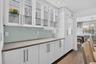 Beautiful illuminated glass cabinets, the under cabinet lighting design provides a unique glow against the custom designed backsplash. Take a look at