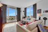 Living room with wood finished floors, expansive windows, and a view of city