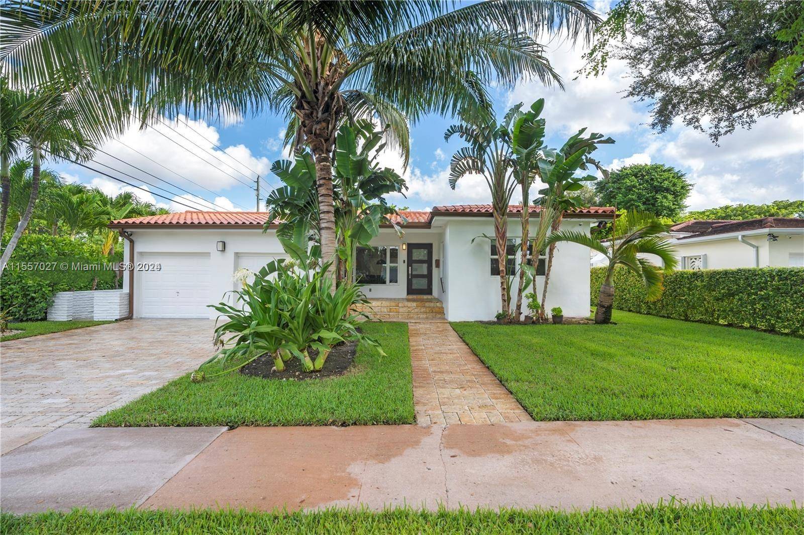 Renovated Coral Gables home featuring 3 bedrooms and 2 baths with stunning modern wood flooring throughout.