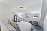 Bedroom featuring wood finished floors and radiator heating unit