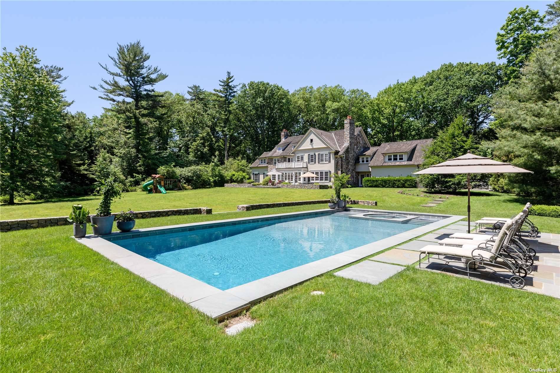 Presiding on over 3 pristine acres, this exquisite Colonial residence, constructed in 2003, offers exceptional privacy and serenity in the heart of the Village of Old Westbury.