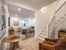 Living area featuring stairs, light wood-style floors, and recessed lighting