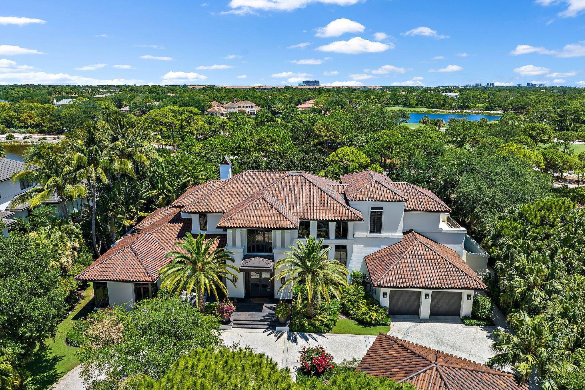 Located on nearly an acre along the second hole of the Nicklaus signature course at The Bears Club, this custom estate residence seamlessly integrates modern elements with timeless charm.