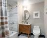 Full bath featuring shower / bathtub combination with curtain, vanity, and light tile patterned floors