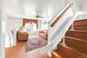 Living room featuring stairs, wood finished floors, and a ceiling fan