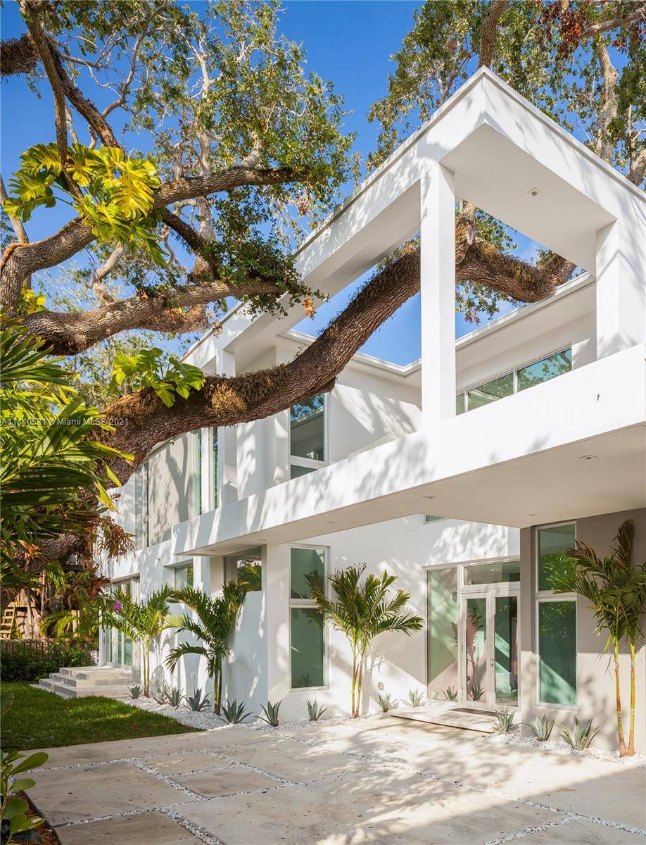 Built in 2018, this stunning modern home redefines luxury living tucked away on a secluded North Coconut Grove oasis.