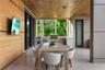 Covered terrace with built-in outdoor kitchen, stainless steel gas grill, stone counters, wood-plank ceiling, recessed lighting, teak dining table, wo