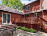 Rear view of house featuring a patio area, a deck, and french doors