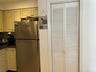 Stainless refrig and pantry closet.