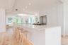 Kitchen featuring stainless steel fridge, recessed lighting, open floor plan, light wood-style flooring, and a spacious island