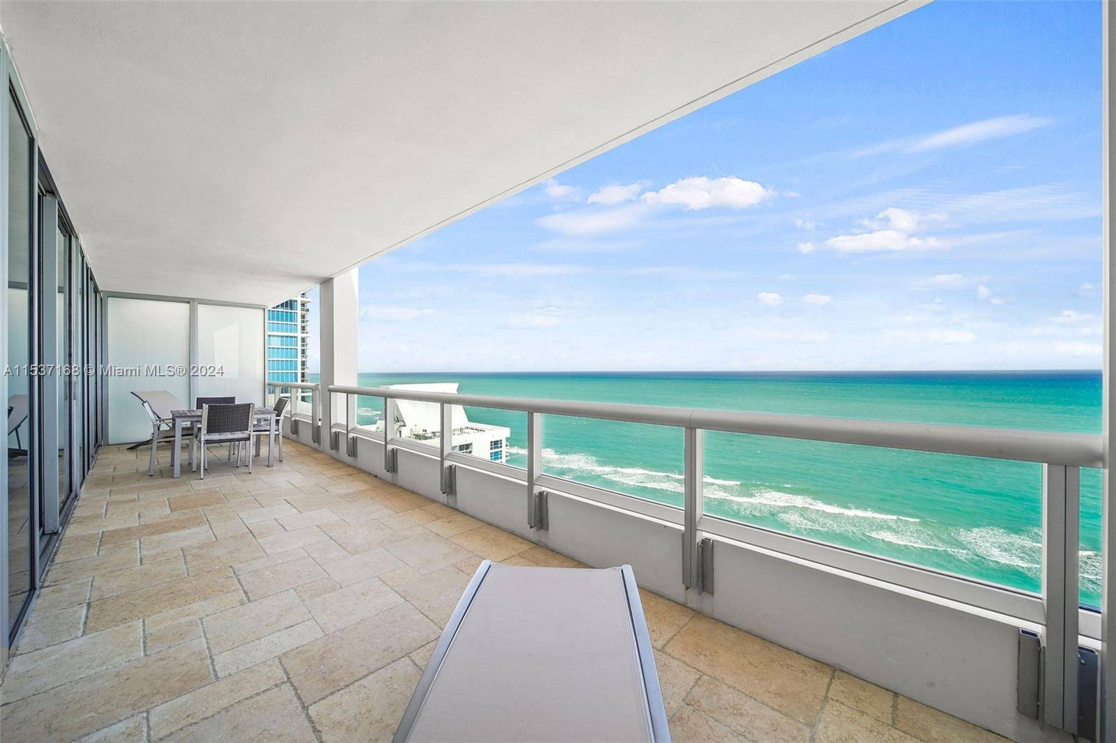 STUNNING DIRECT OCEAN VIEW from all rooms of Penthouse unit with large, deep balcony spanning living and bedrooms at Carillon Miami Wellness Resort, a premier oceanfront luxury property.
