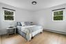 Bedroom featuring baseboard heating and light wood-style floors