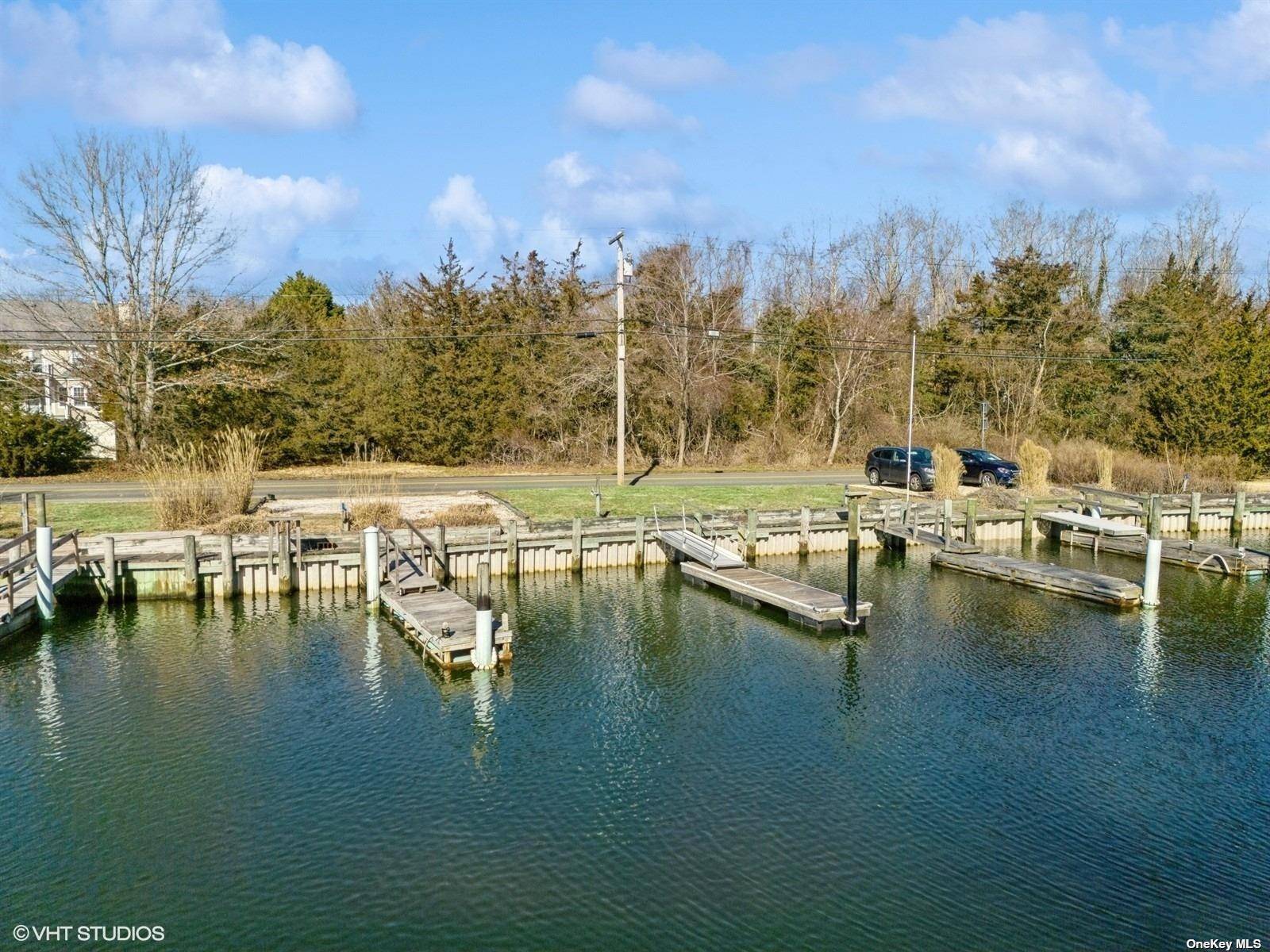 Jamesport Design and build your dream home on this shy acre property with 2 Boat slips on canal leading to Peconic Bay.