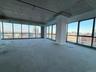 Empty room with healthy amount of natural light, a city view, and concrete floors