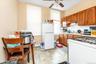 Kitchen with sink, ceiling fan, white appliances, and backsplash
