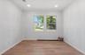 Room featuring wood-finish flooring, recessed lighting, and white walls