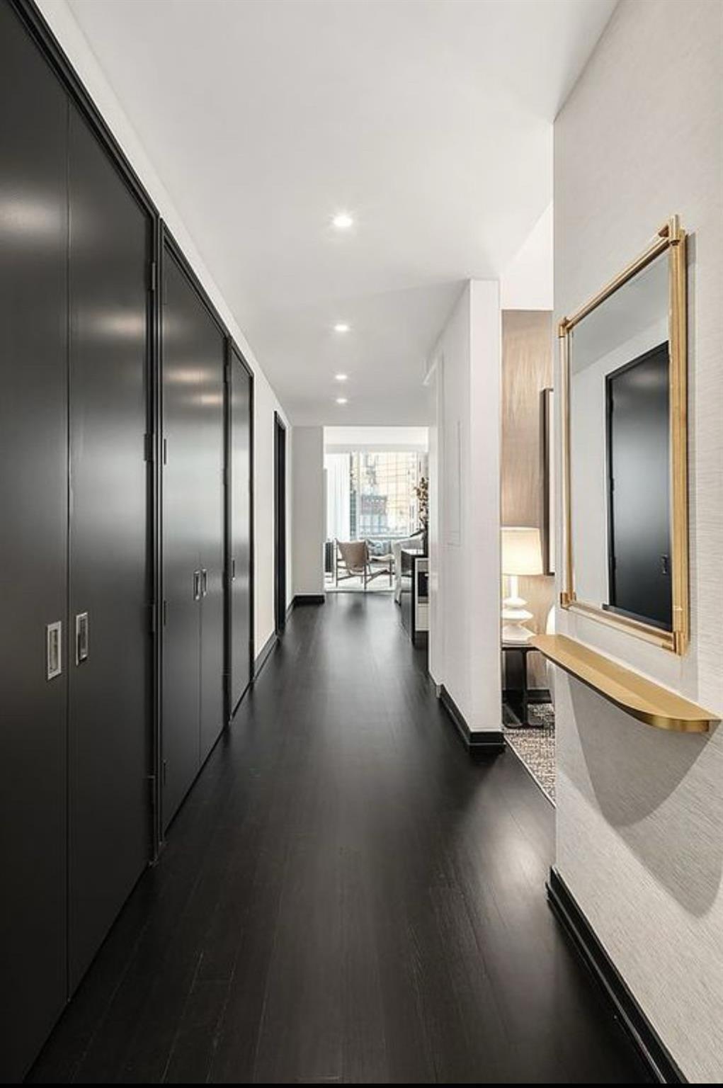 Hall with dark hardwood / wood-style flooring