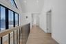 Beautiful second floor landing with large windows providing natural light.