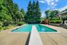 In ground pool with diving board and walk-in steps... 38 ft wide ... 3FT low end up to 9FT deep end