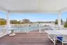 Covered Deck with Dining Area Overlooking Pool