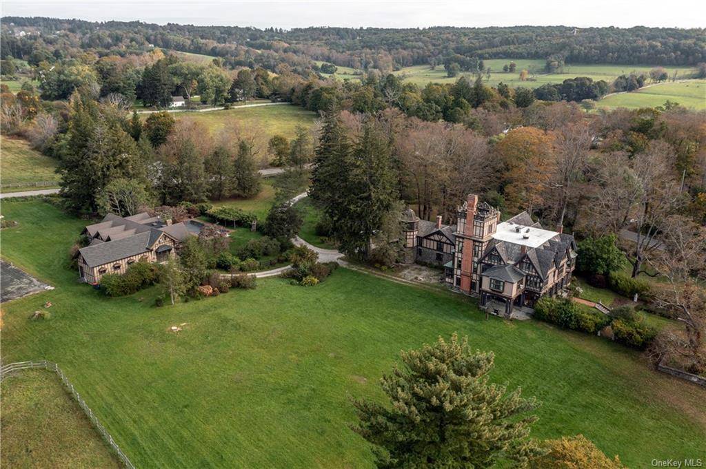 25. 5 acre equestrian estate with a 43 room Elizabethan Style manor house, two caretaker homes, a carriage house with groom's quarters, a yoga studio, a 12, 000 sq.
