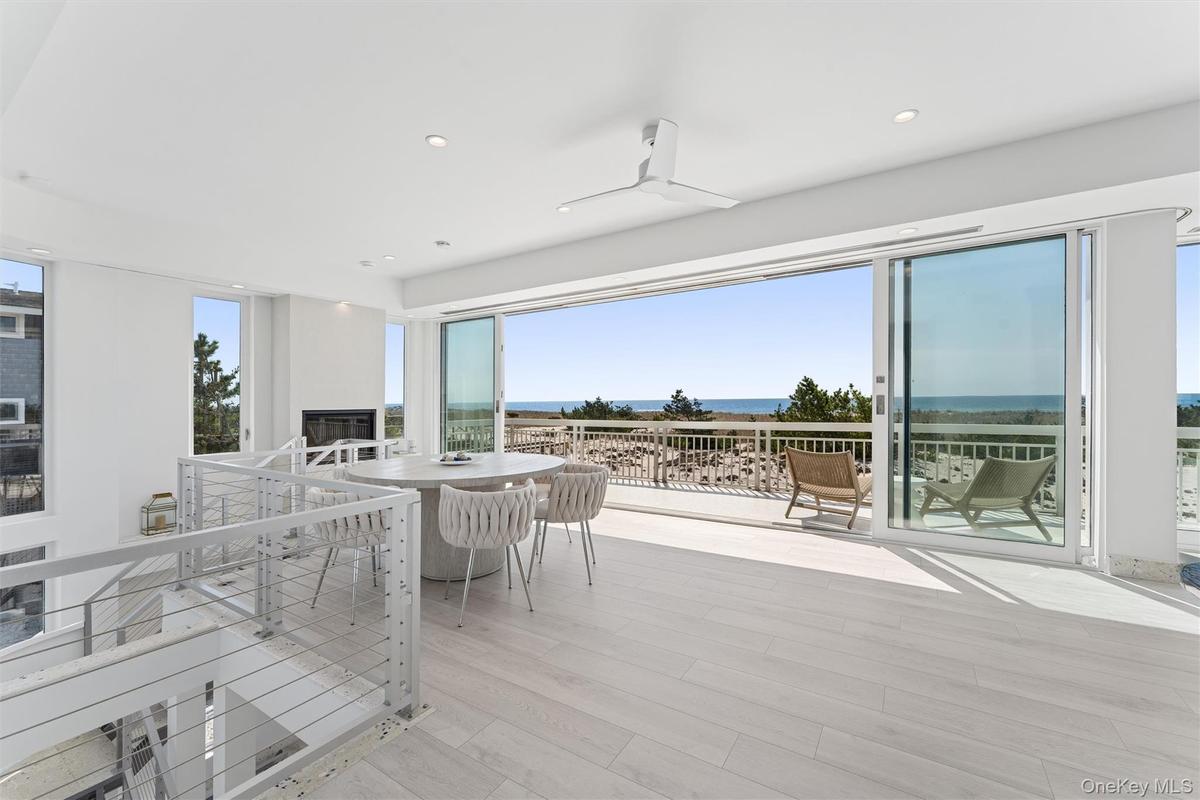 Wooden deck featuring a water view and outdoor dining area
