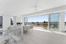 Wooden deck featuring a water view and outdoor dining area