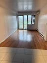 Unfurnished room with tile patterned flooring, a baseboard heating unit, and a wall unit AC