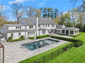 This mid Country six bedroom classic New England home is gated and tucked back on two beautifully landscaped acres.