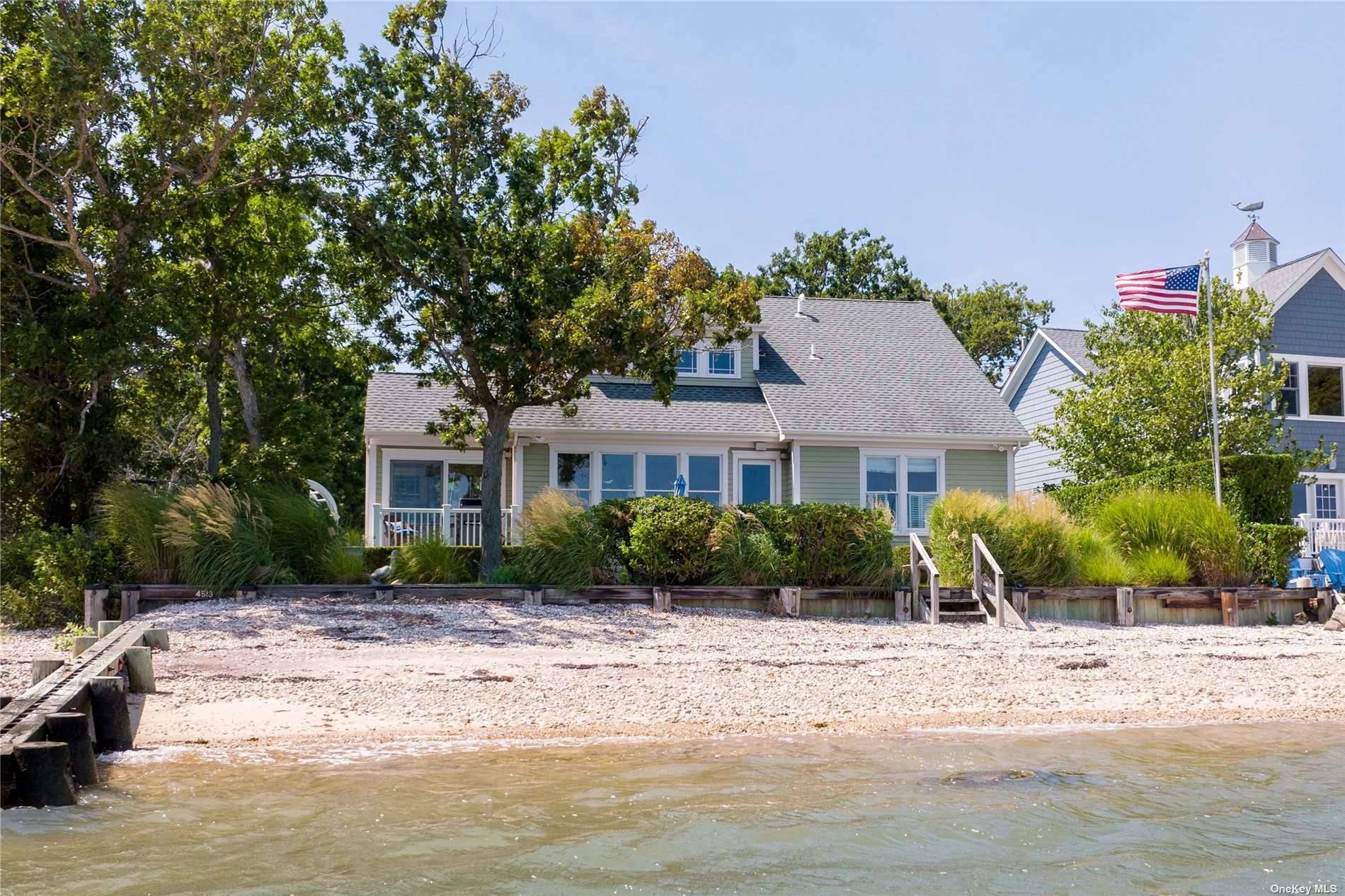 Nestled among the shores of Pipes Cove, this exquisite bayfront home offers the ultimate beach lifestyle, combining relaxation and panoramic views around Conkling Point over to Shelter Island.