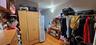 Walk in closet with light wood finished floors