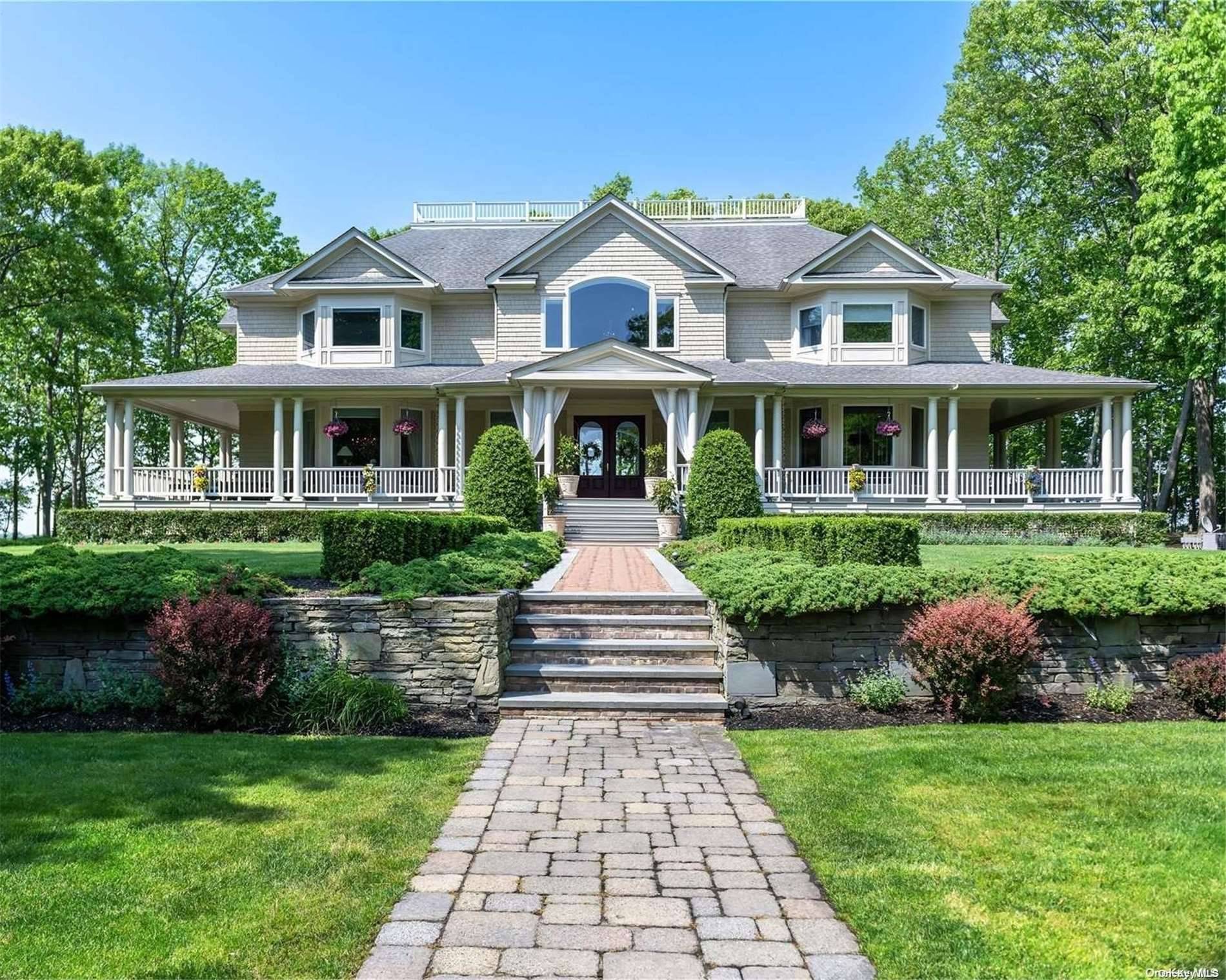 Discover the charm of waterfront living on this 8 acre estate along Southold Bay, boasting 157 feet of pristine shoreline and a private beach for tranquil retreats.