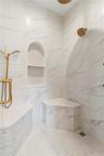 Primary shower with 3 separate water features, rain head, hand held, and wall mount