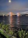Stunning evening views of the illuminated bridge reflecting across the river