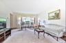 Carpeted living area featuring baseboards