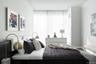 Bedroom with hardwood / wood-style floors and multiple windows