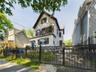 View of front of house with a fenced front yard and a gate