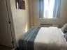 Bedroom featuring a wall mounted air conditioner