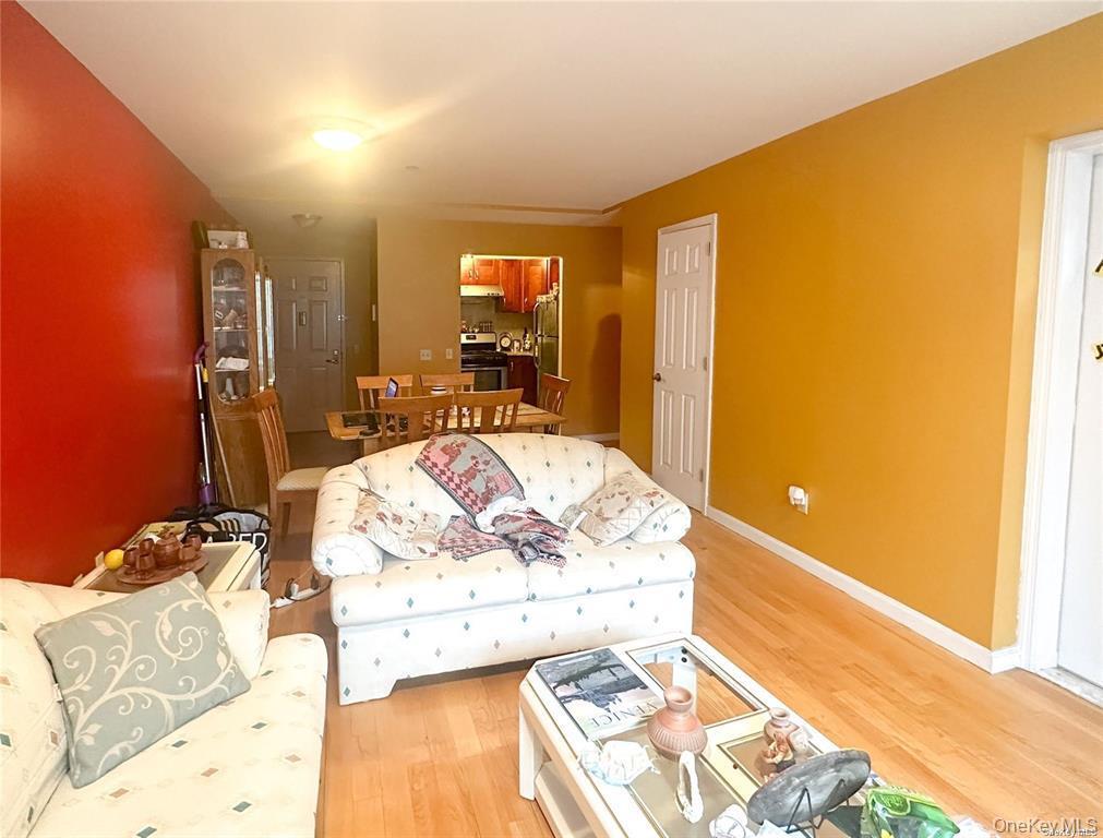 Living room featuring light wood-type flooring and baseboards