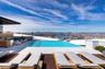 View of swimming pool featuring an infinity pool, a patio area, and a rooftop deck