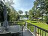 Wooden deck featuring a water view and outdoor dining area