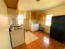 Kitchen featuring freestanding refrigerator, gas range gas stove, healthy amount of natural light, and radiator