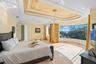 Bedroom 2 on the third level features a curved floor-to-ceiling window with endless views of the gr