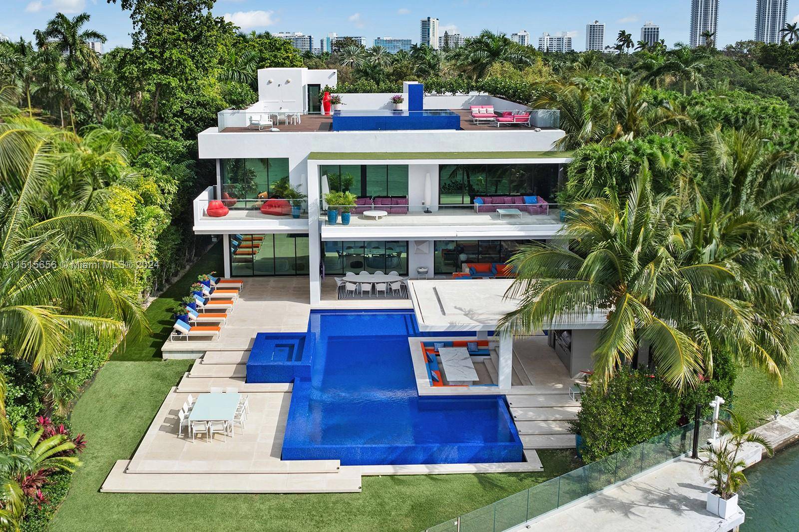 Situated on prestigious North Bay Road, this contemporary waterfront home epitomizes elegance and style.