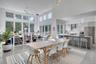 Dining room with ceiling fan, light hardwood / wood-style flooring, a towering ceiling, and sink