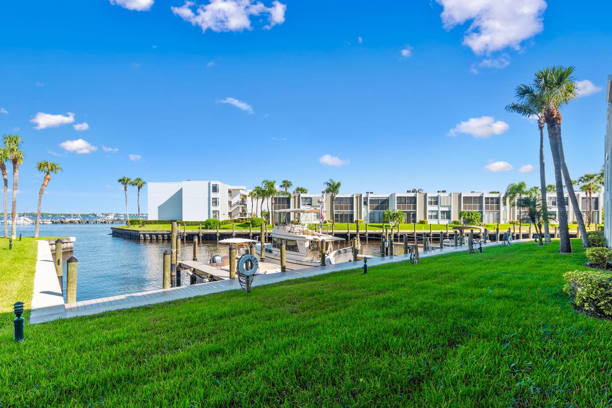 Fantastic Opportunity to own this first floor 2 bed 2 bath condo with a beautiful wide water view in one of the most sought after 55 boating communities in Stuart.