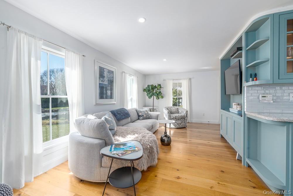 Living room featuring light wood finished floors, recessed lighting, and baseboards