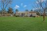 Back of house and yard featuring pergola and patio,