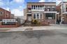 View of front of property featuring brick siding and a balcony
