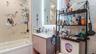 Full bath with in the Primary Bedroom featuring shower / bath combination, vanity, and tasteful backsplash